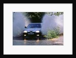 1989 Alfa Romeo 164 driving through a ford by Unknown