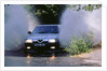 1989 Alfa Romeo 164 driving through a ford by Unknown