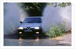 1989 Alfa Romeo 164 driving through a ford by Unknown
