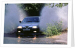 1989 Alfa Romeo 164 driving through a ford by Unknown