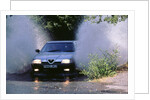 1989 Alfa Romeo 164 driving through a ford by Unknown