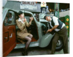 Mechanic with lady driver doing her make up, 1930's Hillman Minx by Unknown