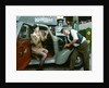 Mechanic with lady driver doing her make up, 1930's Hillman Minx by Unknown