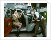 Mechanic with lady driver doing her make up, 1930's Hillman Minx by Unknown