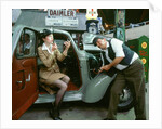 Mechanic with lady driver doing her make up, 1930's Hillman Minx by Unknown