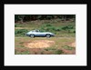 1965 Jaguar E type with smiling driver by Unknown