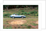 1965 Jaguar E type with smiling driver by Unknown