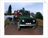 Child driving a toy Land Rover by Unknown