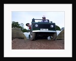 Child driving a toy Land Rover by Unknown