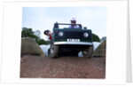 Child driving a toy Land Rover by Unknown