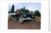 Child driving a toy Land Rover by Unknown