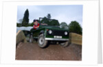 Child driving a toy Land Rover by Unknown