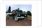 Child driving a toy Land Rover by Unknown