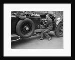 Geoffrey Baker inspecting the engine of a Minerva car by Bill Brunell
