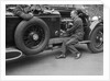 Geoffrey Baker inspecting the engine of a Minerva car by Bill Brunell