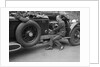 Geoffrey Baker inspecting the engine of a Minerva car by Bill Brunell