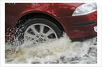 Car driving through flood by Unknown
