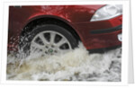 Car driving through flood by Unknown