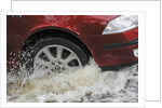Car driving through flood by Unknown