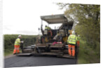 Road resurfacing work repairing potholes by Unknown