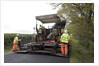 Road resurfacing work repairing potholes by Unknown