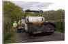 Road resurfacing work repairing potholes by Unknown