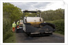 Road resurfacing work repairing potholes by Unknown