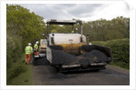 Road resurfacing work repairing potholes by Unknown