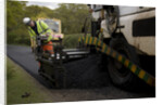 Road resurfacing work repairing potholes by Unknown