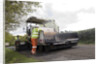 Road resurfacing work repairing potholes by Unknown