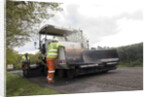 Road resurfacing work repairing potholes by Unknown