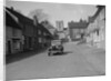 Standard Sixteen saloon driving down the High Street, Hambledon, Hampshire, 1930s by Bill Brunell