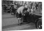Kitty Brunell in her Aston Martin, chatting to a man in Highland dress, RSAC Scottish Rally, 1933 by Bill Brunell