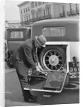 A driver opening the fitted toolkit of his Ford Model A at the Southport Rally, 1928 by Bill Brunell