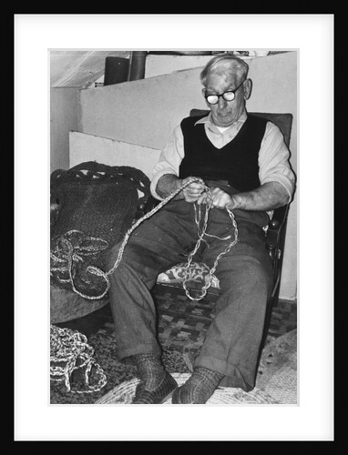 Mr L. Marling making repe mats by Unknown