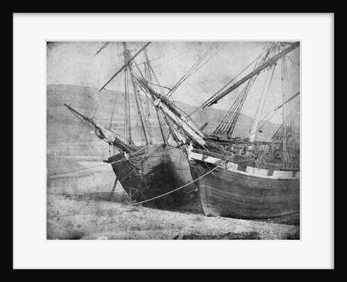 Bow view of two unidentified vessels at low tide by unknown