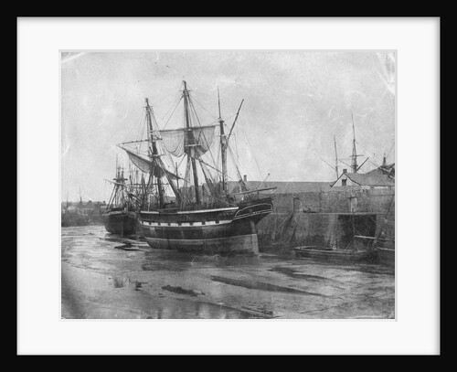 Stern quater view of copper ship and others aground at low tide by unknown