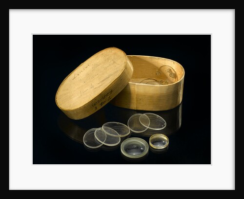 Nine lenses of various sizes in a box by Unknown