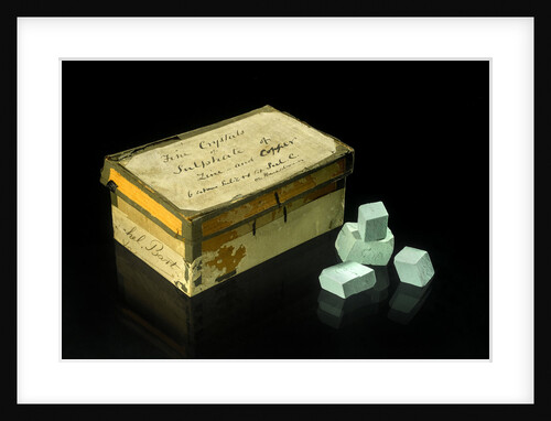 A box containing twenty one turquoise blue opaque crystals by unknown