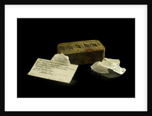 A tobacco tin containing pieces of quartz. by Unknown