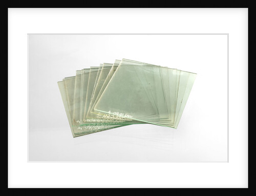 Thirteen clean cut glass squares in a box by unknown