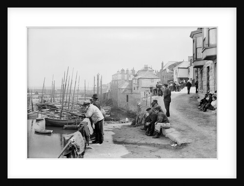 Newlyn Harbour, Cornwall. The old harbour with fishermen looking out to sea. by Francis Frith & Co.