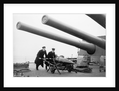 Two ratings pushing a 14-inch shell on a trolley on the battleship 'King George V' (1939). King George V carried about 800 shells for her 10 guns when loaded. by unknown