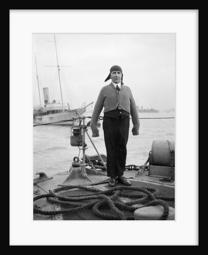 Gunner William G. Worsh of the destroyer 'Swallow' proudly showing off his latest comforts from home, a hand-knitted cardigan and balaclava by Unknown