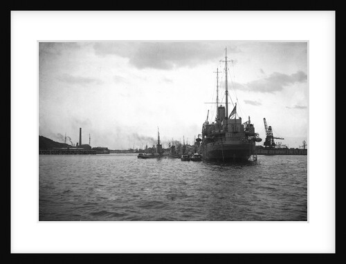 HMS 'Titania' (1915) submarine depot ship, moored at Portland with 4 submarines alongside by unknown