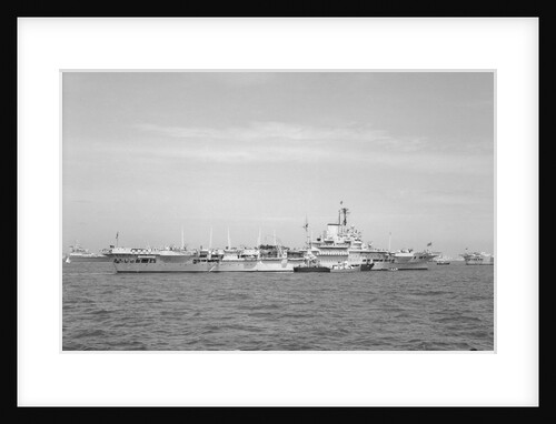 Aircraft carrier HMS 'Illustrious' (1939) in June 1953, anchored in Line F at Spithead for the Coronation Review. The aircraft lighter 'R.N.AIR' is alongside by unknown