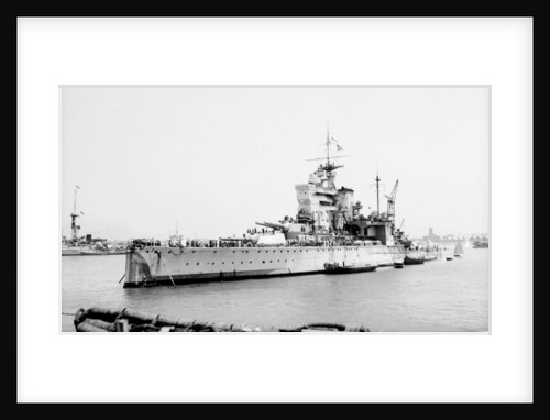 Battleship HMS 'Valiant' (1914) anchored in Alexandria harbour taking on ammunition by unknown