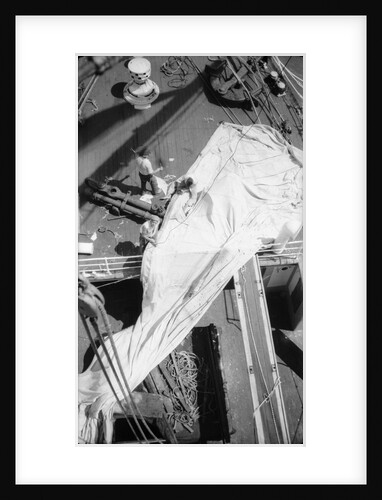 Repairing a spread sail on the forecastle by Alan Villiers