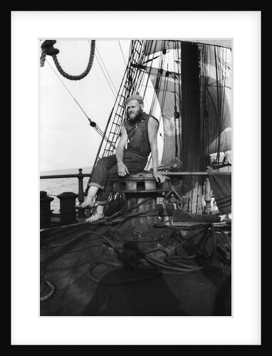 One of the crew on the forecastle head capstan by Alan Villiers
