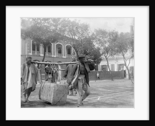 Two Chinese men carrying a load suspended from a pole between them by Kenneth Hurlstone Jones